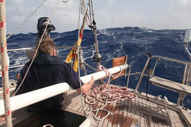 Putting the pole in place as a jury rigged rudder - notice drogue still in place. © SW